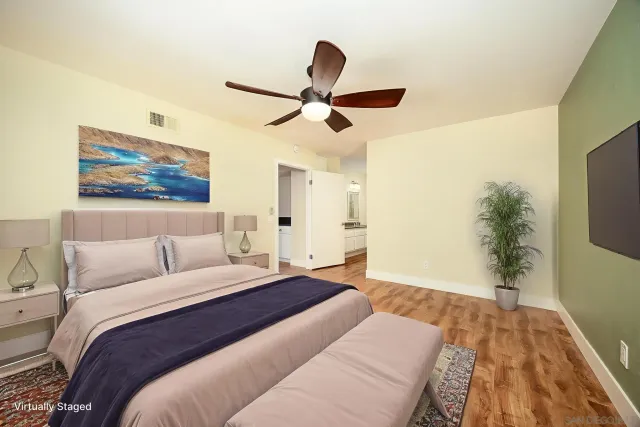 a bed room with a bed and a flat screen tv