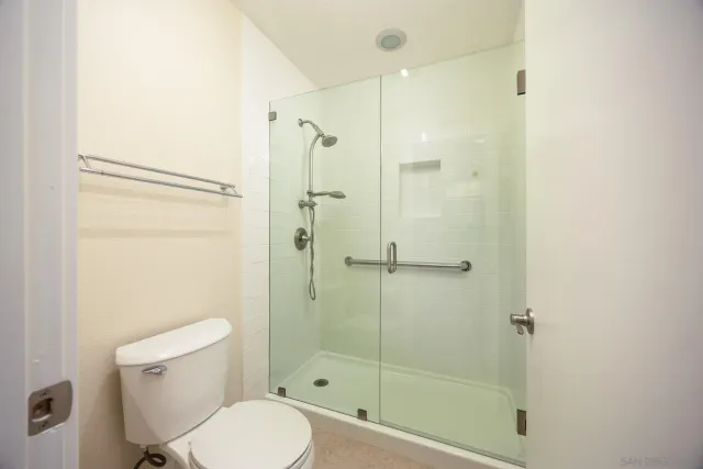 a bathroom with a toilet and shower