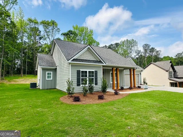 a view of a house with a yard porch and sitting area