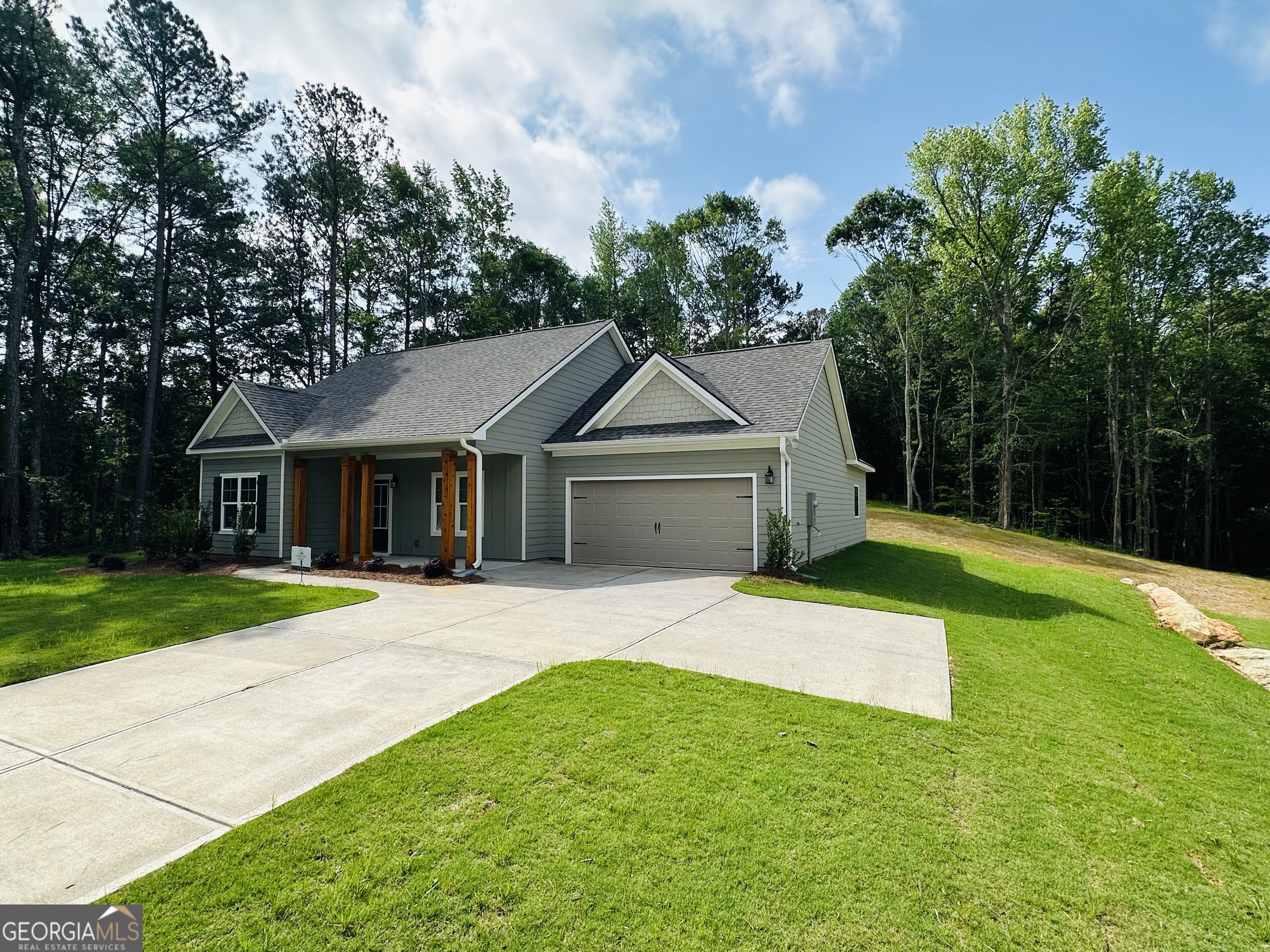 25 Patterson Drive Franklin, GA 30217 - Photo 6 of 36 a front view of a house with a yard and garage
