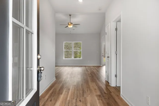 wooden floor in an empty room with a window