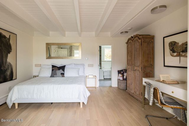 a bedroom with a bed and a table in it