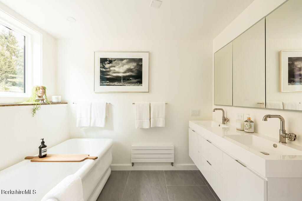 302 A Egremont Plain Road Egremont, MA 01230 - Photo 29 of 66 a bathroom with a tub sink and mirror