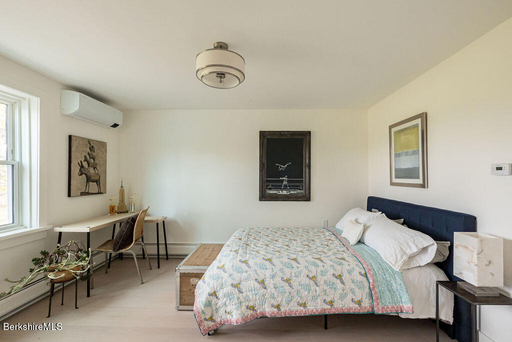 302 A Egremont Plain Road Egremont, MA 01230 - Photo 35 of 66 a bedroom with a bed and a table in it