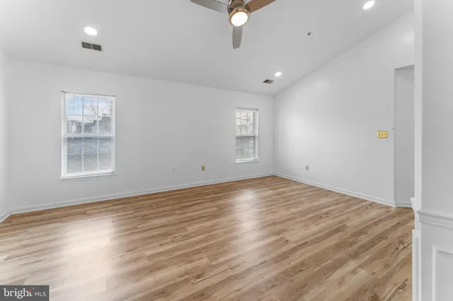a spacious bathroom with a tub a sink and mirror