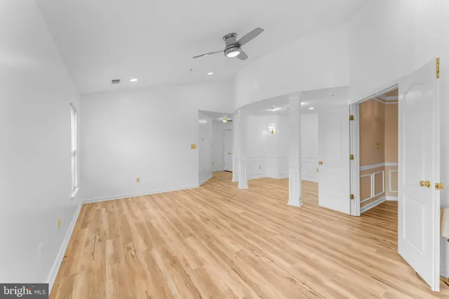 an empty room with windows and closet