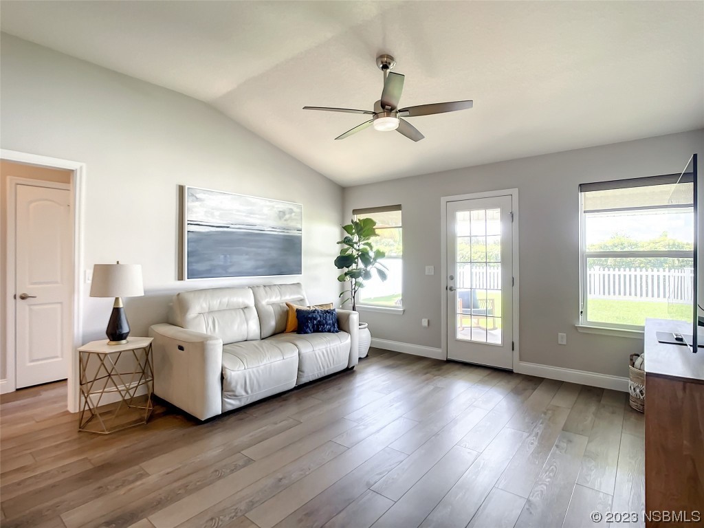 512 Coral Trace Boulevard Edgewater, FL 32132 - Photo 12 of 45 a living room with furniture and a large window
