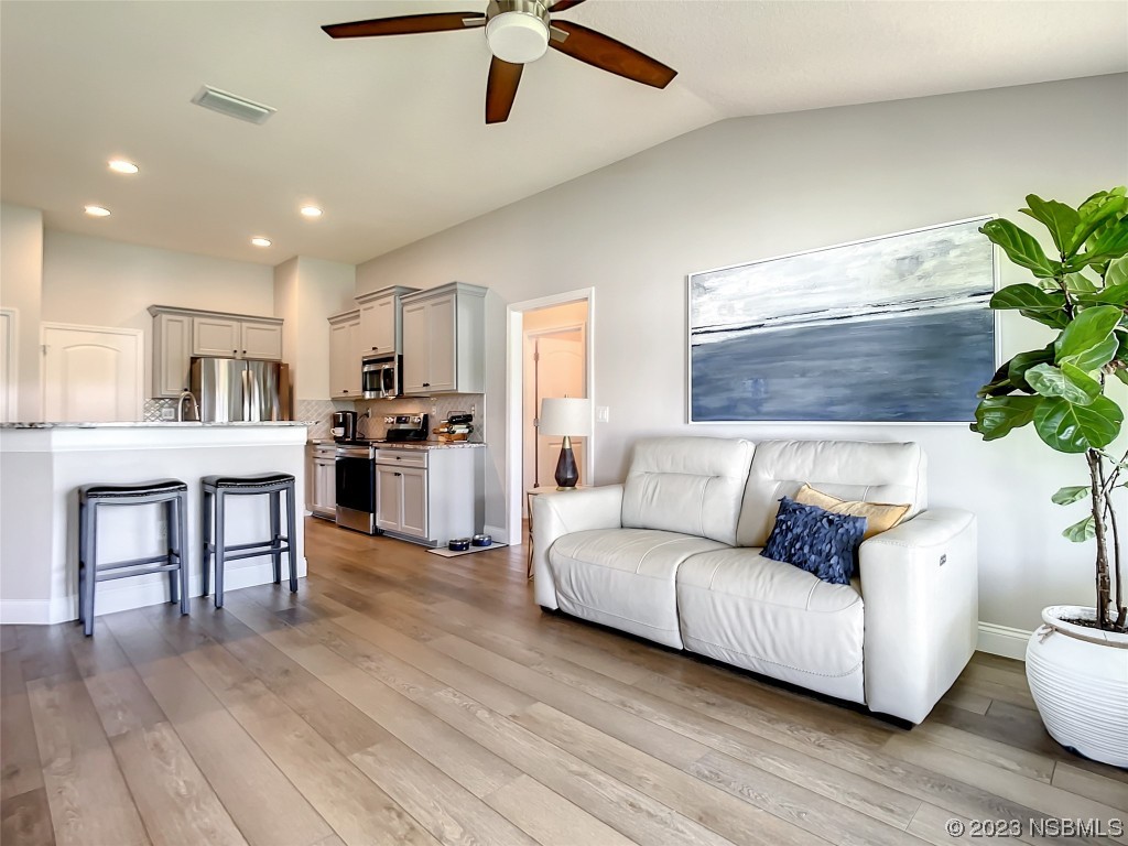 512 Coral Trace Boulevard Edgewater, FL 32132 - Photo 13 of 45 a living room with furniture and kitchen view