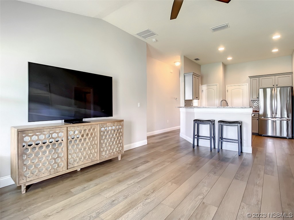 512 Coral Trace Boulevard Edgewater, FL 32132 - Photo 14 of 45 a living room with furniture and a flat screen tv