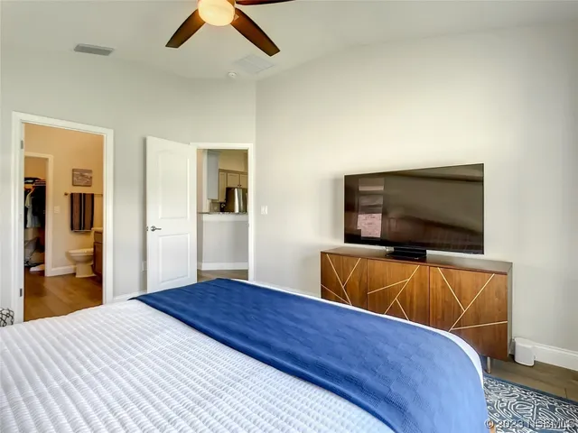 a bedroom with a bed and a flat screen tv