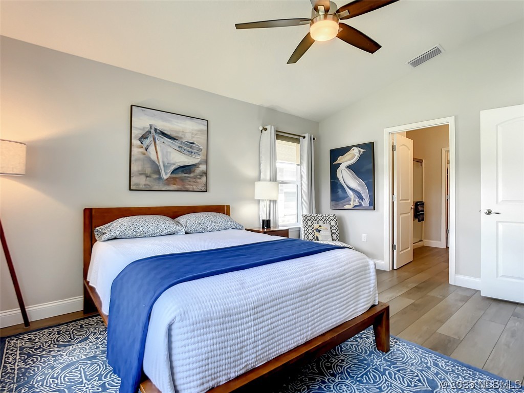 512 Coral Trace Boulevard Edgewater, FL 32132 - Photo 19 of 45 a bedroom with bed and paintings on the wall