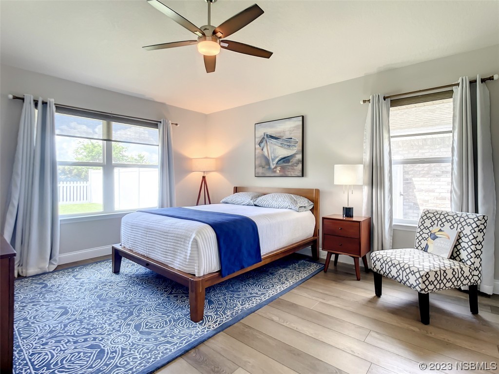 512 Coral Trace Boulevard Edgewater, FL 32132 - Photo 20 of 45 a bedroom with a bed a couch and a window