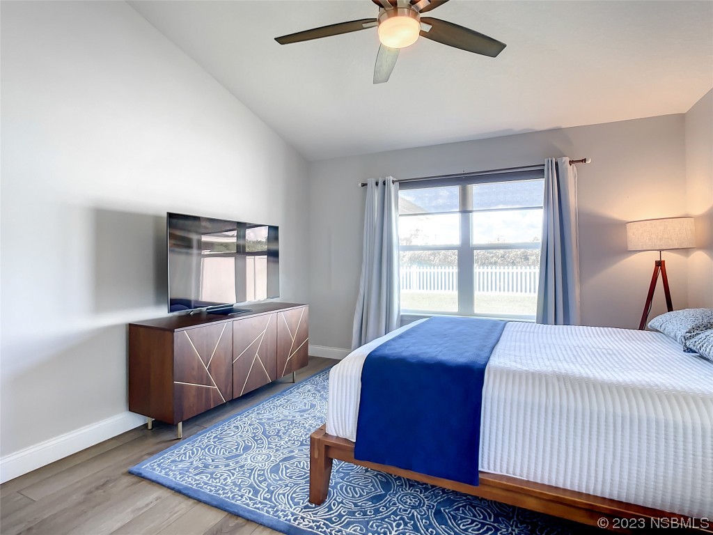 512 Coral Trace Boulevard Edgewater, FL 32132 - Photo 21 of 45 a bedroom with a bed and window