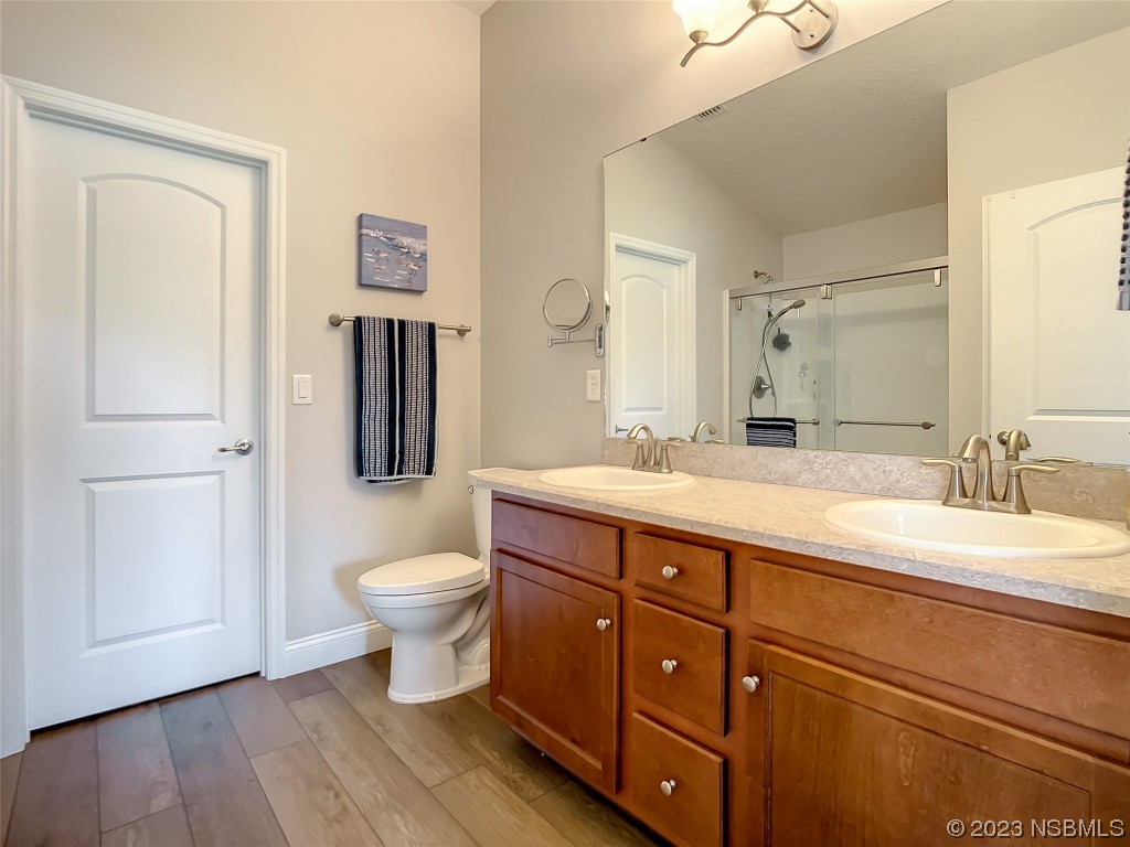 512 Coral Trace Boulevard Edgewater, FL 32132 - Photo 22 of 45 a bathroom with a toilet a sink and mirror