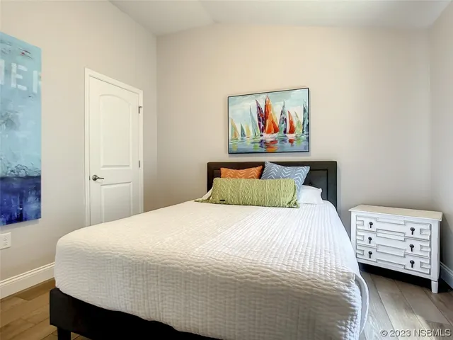 a bedroom with a bed and a painting on the wall