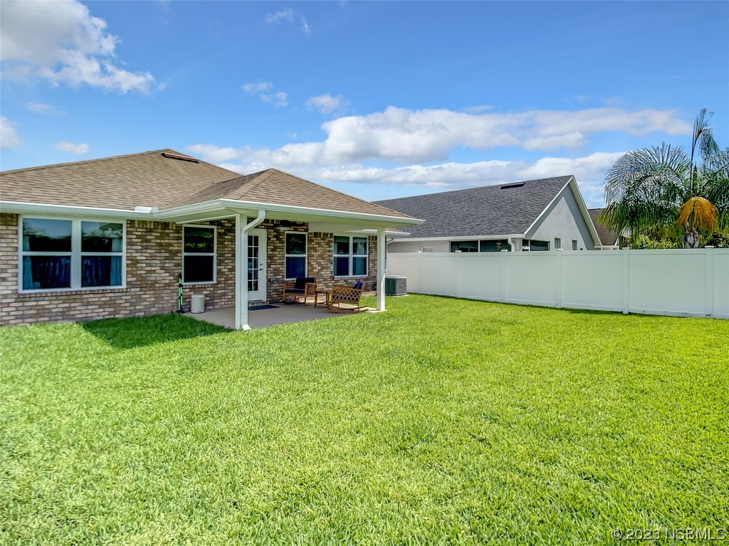 512 Coral Trace Boulevard Edgewater, FL 32132 - Photo 33 of 45 a view of a house with a backyard porch and sitting area