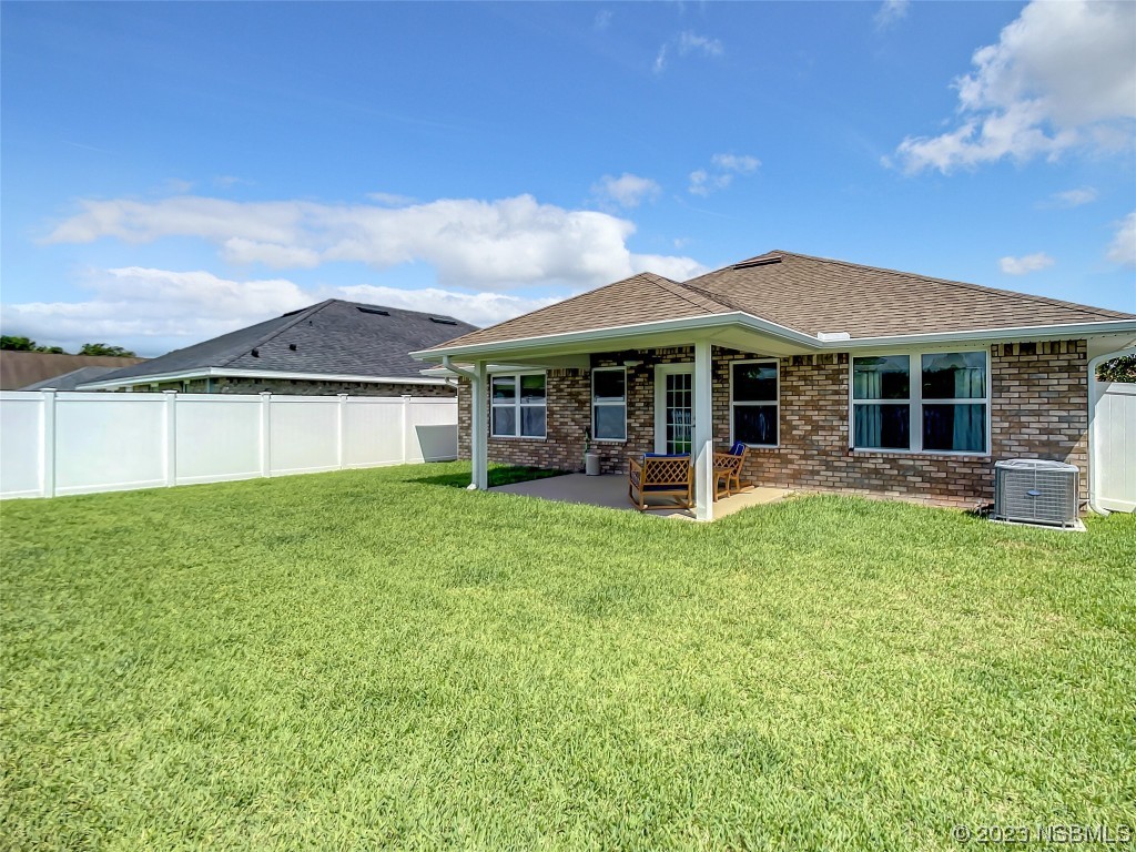 512 Coral Trace Boulevard Edgewater, FL 32132 - Photo 34 of 45 a view of a house with a backyard porch and sitting area