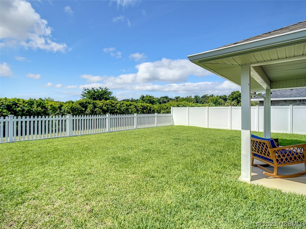 512 Coral Trace Boulevard Edgewater, FL 32132 - Photo 35 of 45 a view of a chair and table in the garden