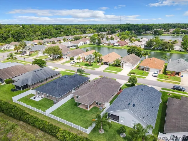 an aerial view of residential houses with outdoor space and street view