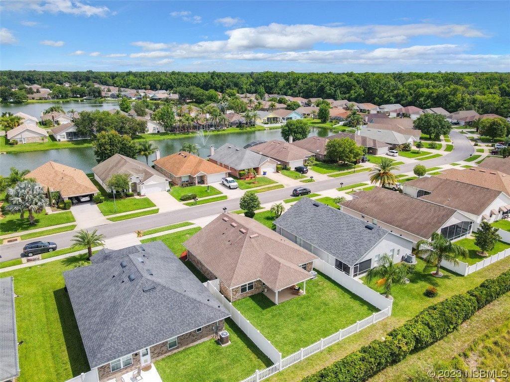 512 Coral Trace Boulevard Edgewater, FL 32132 - Photo 38 of 45 an aerial view of residential houses with outdoor space and river