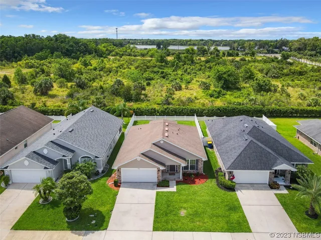 an aerial view of a house with a yard