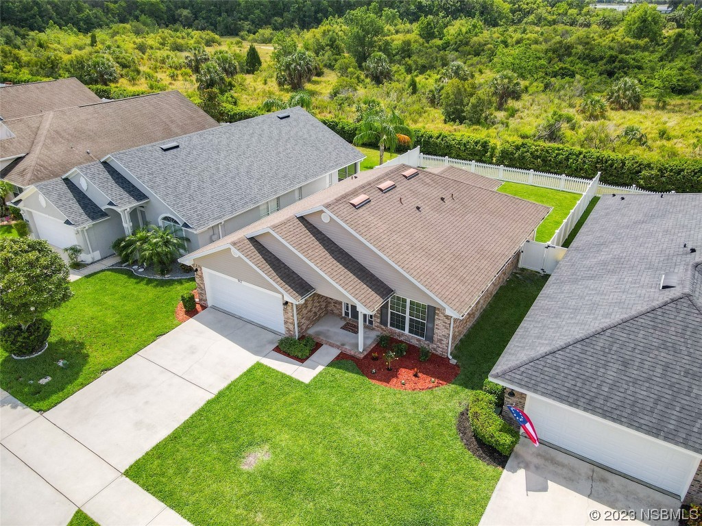 512 Coral Trace Boulevard Edgewater, FL 32132 - Photo 43 of 45 an aerial view of a house with a big yard