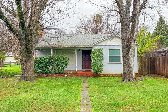 a front view of house with a garden