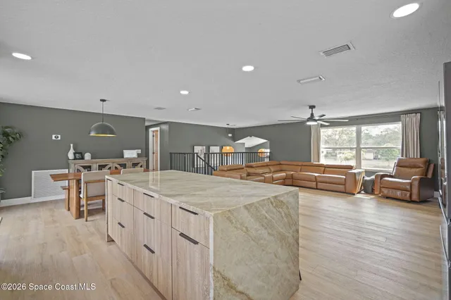 a large white kitchen with a large window