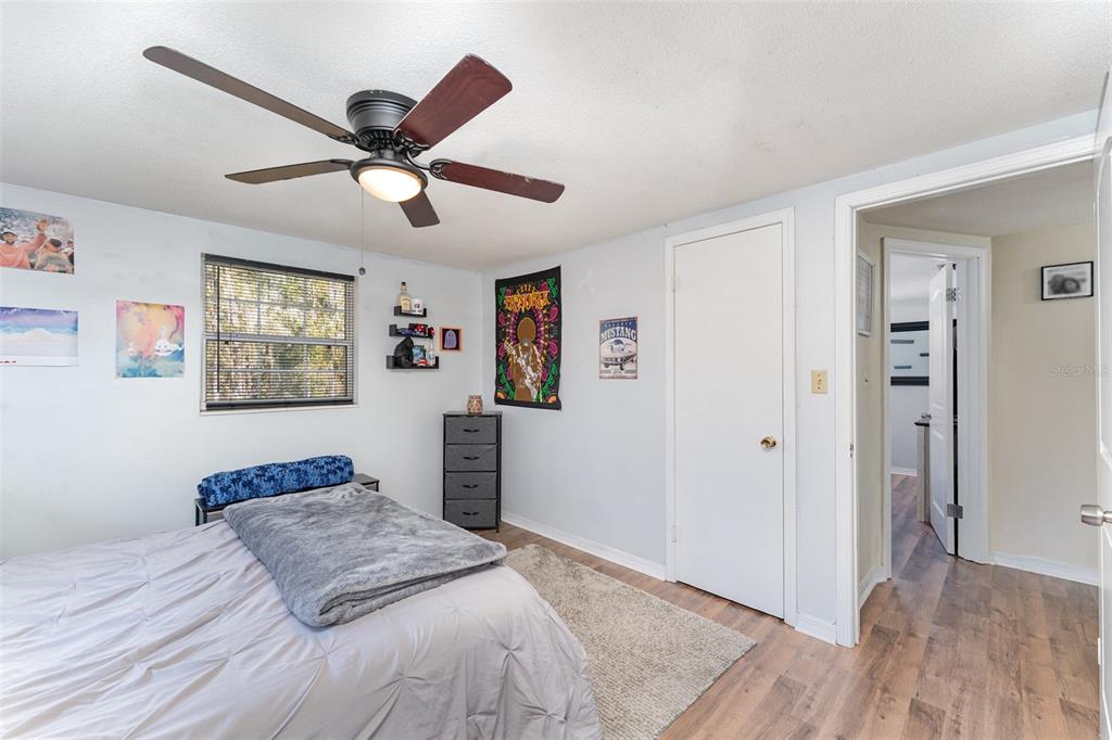 4145 Willow Oak Road Mulberry, FL 33860 - Photo 15 of 30 a bedroom with a bed and a chandelier