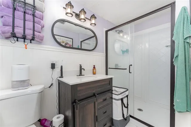 a bathroom with a sink mirror vanity and toilet