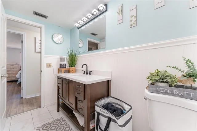 a bathroom with a sink mirror and vanity