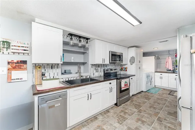 a kitchen with a sink cabinets and window