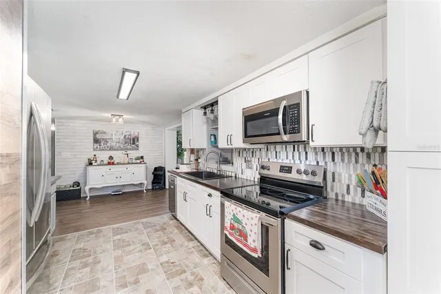 a kitchen with stainless steel appliances granite countertop a stove and a sink
