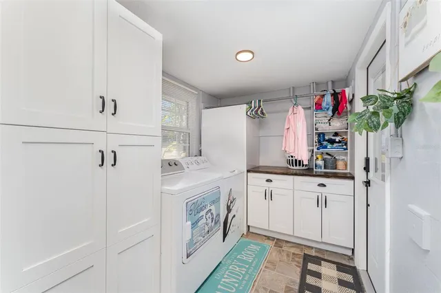a kitchen with granite countertop a white cabinets and white appliances