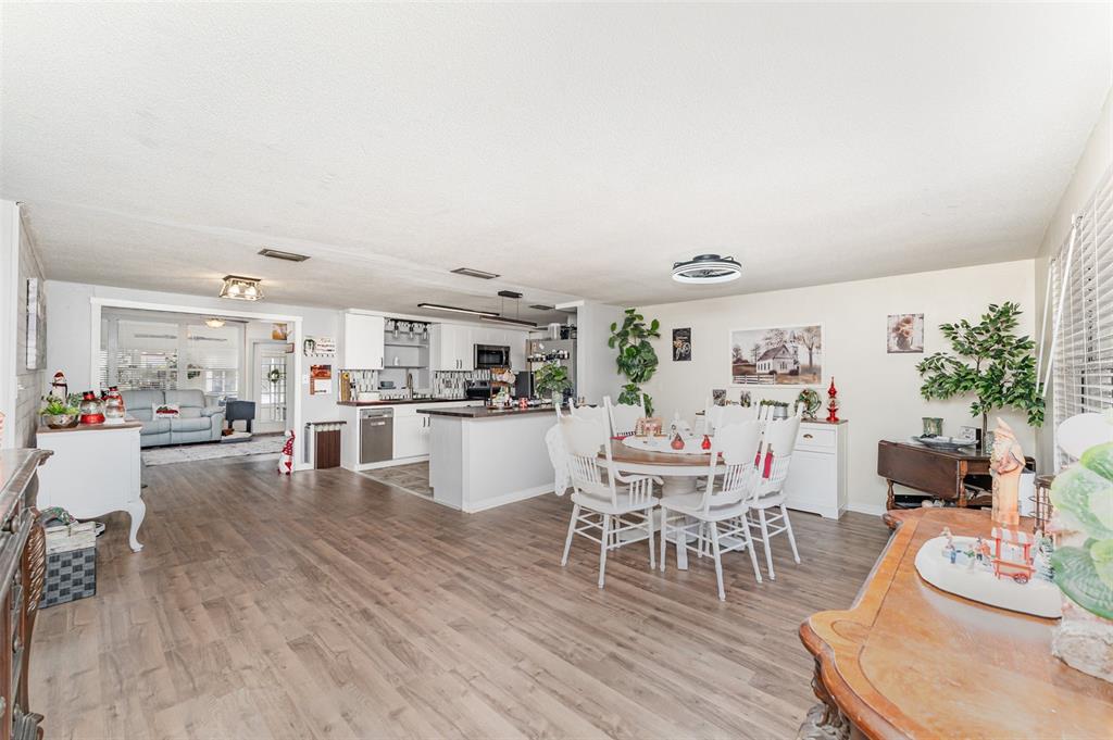 4145 Willow Oak Road Mulberry, FL 33860 - Photo 4 of 30 a dining room with kitchen island wooden floor and view kitchen