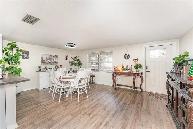 a dining room with furniture and wooden floor