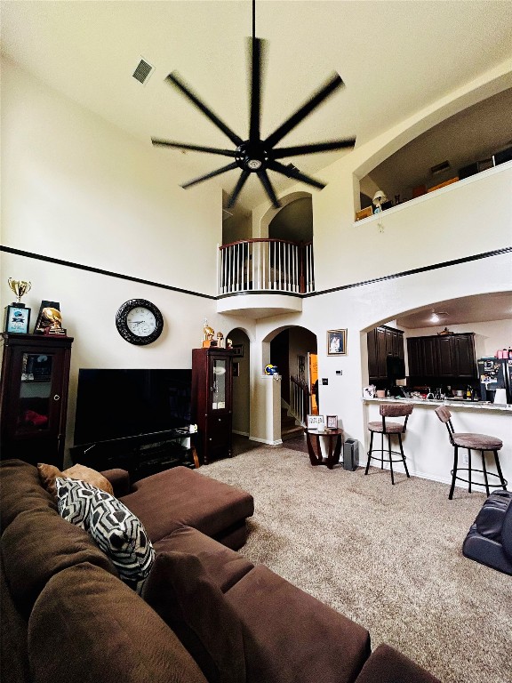 a living room with furniture a flat screen tv and gym equipment