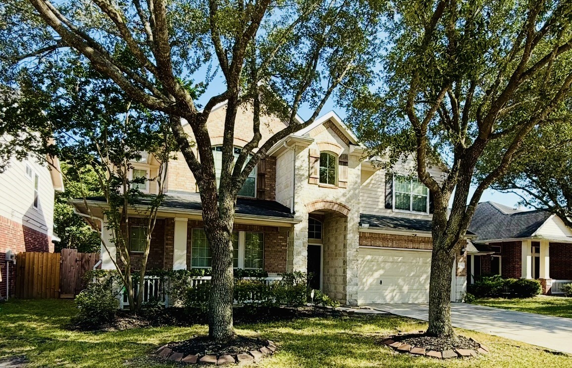 a front view of a house with yard and garage