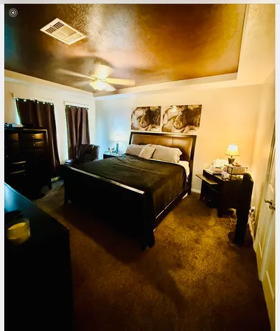 a bed sitting in a bedroom next to a window