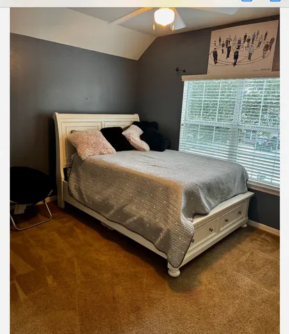 a bedroom with a bed and window