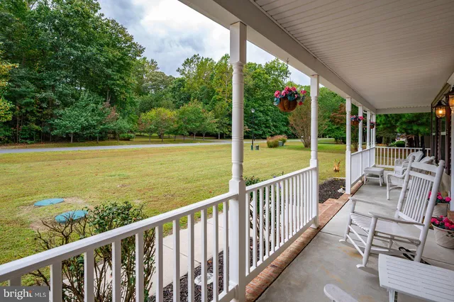a view of balcony with floor to ceiling window next to a yard