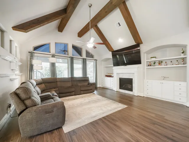 a living room with furniture fireplace and flat screen tv