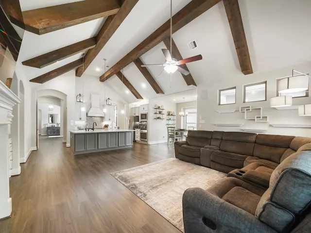 a living room with stainless steel appliances kitchen island granite countertop furniture and a kitchen view