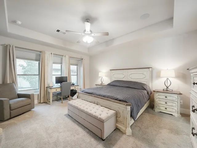 a spacious bedroom with a bed and a couch