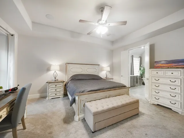 a bedroom with a bed a lamp and a chandelier