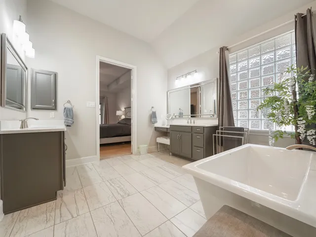 a large white kitchen with a sink and cabinets