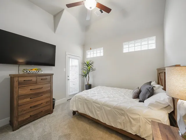 a bedroom with a bed and a flat screen tv