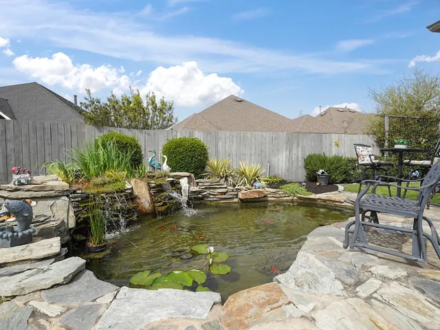 a view of swimming pool with outdoor seating and plants