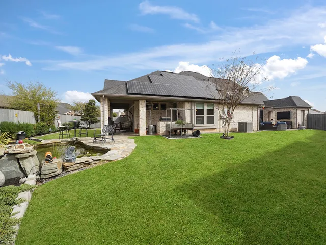 a front view of a house with swimming pool having outdoor seating