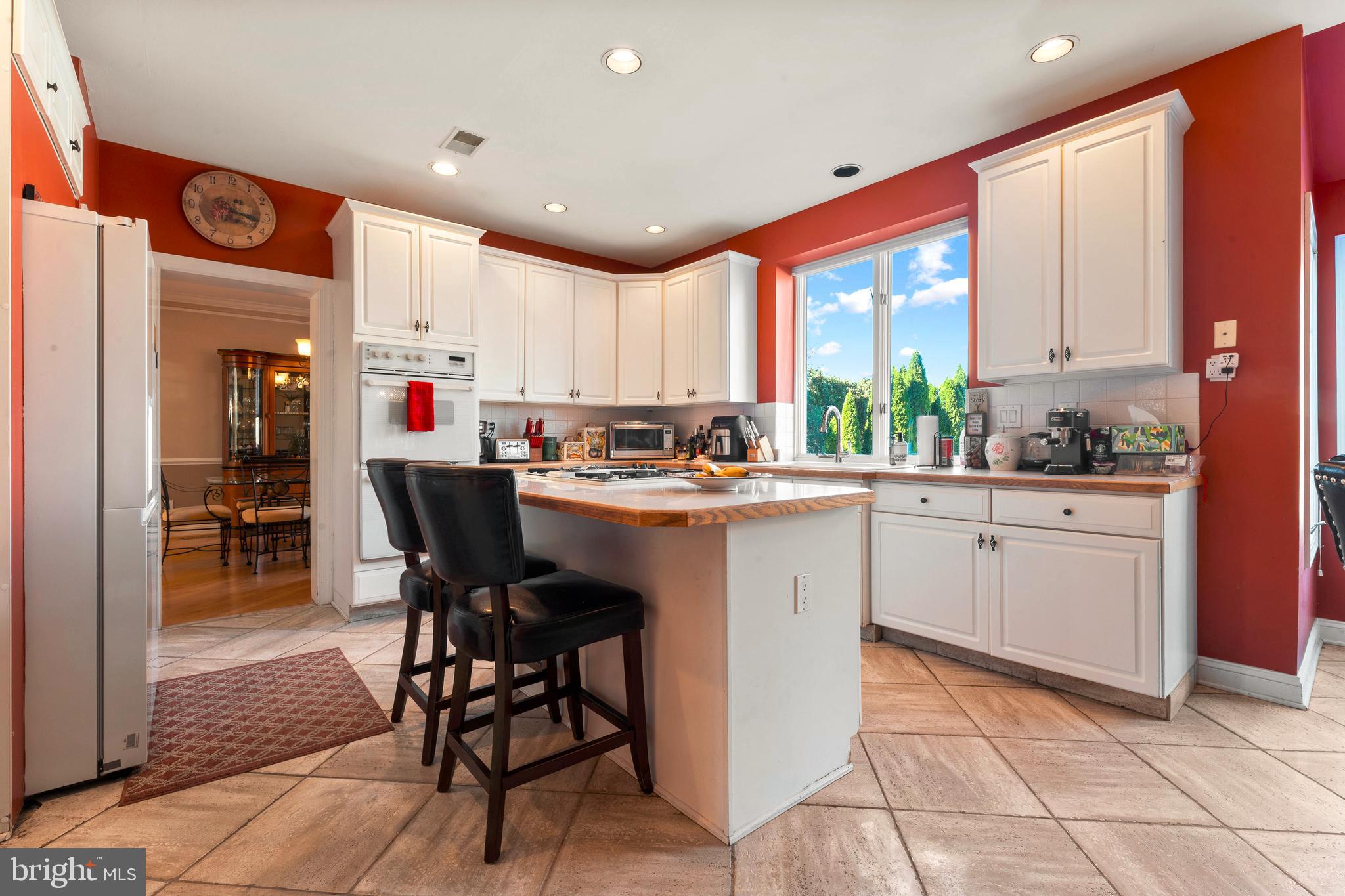 67 Lenape Road Richboro, PA 18954 - Photo 9 of 43 a kitchen with a sink chairs and white cabinets